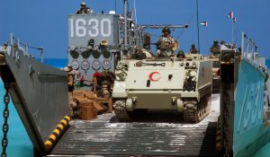 An Egyptian Army M113 Armored Personnel Carrier lead convoy of Royal Jordan Army Vehicles offloading from a US Navy (USN) Landing Craft Utility (LCU-1630) craft assigned to Assault Craft Unit One (ACU-1), on the beach at Mubarek Military City, Egypt, in preparation for an amphibious assault landing demonstration in support of Exercise BRIGHT STAR 2005. The exercise is an important part of US Central CommandÕs (USCENTCOM) theater engagement strategy and is designed to improve readiness, interoperability, strengthen the military and professional relationships among participating forces.