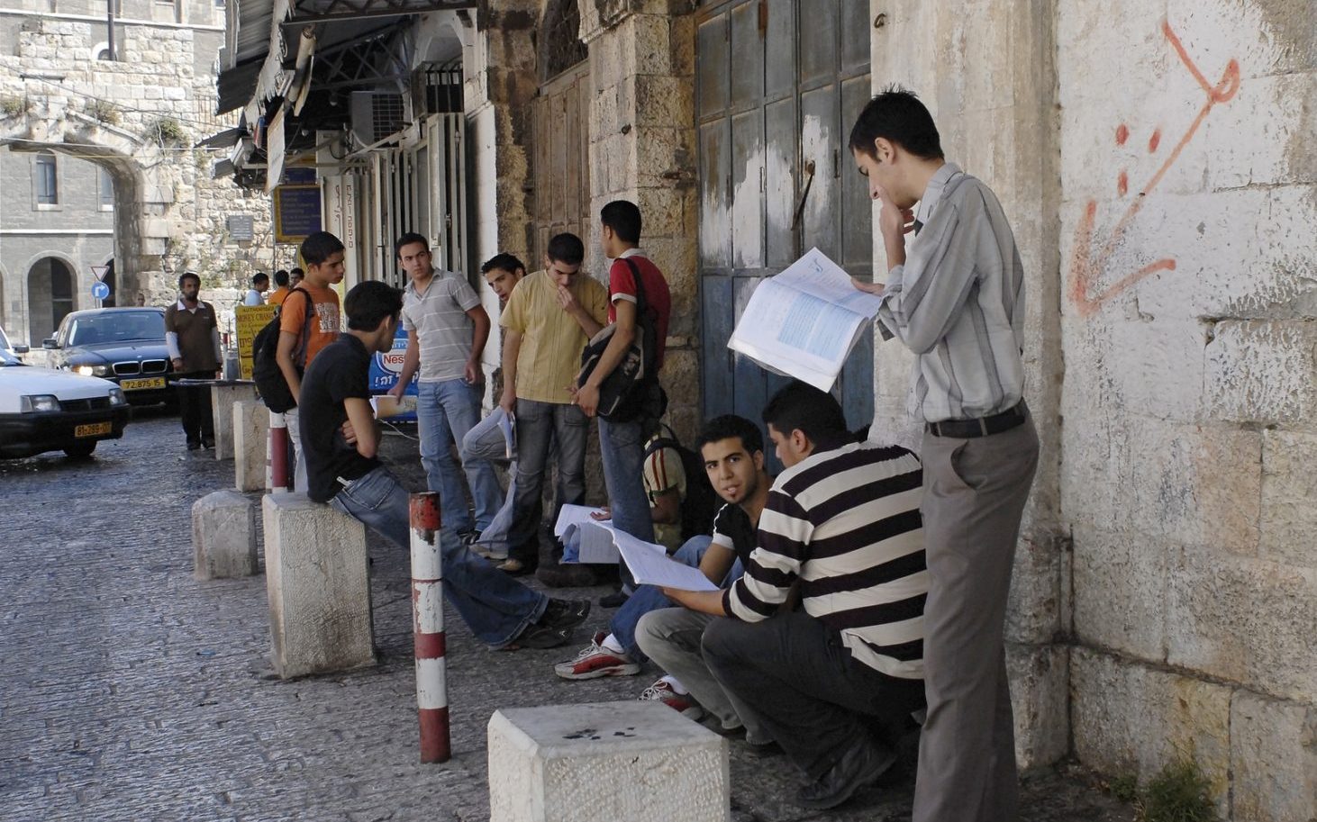 JERUSALEM JUNE 12: Group of young, male, Arab students stand inside the New Gate on Bab El-Jadid Street in Old City, Jerusalem, Israel, studying for their final graduation exams on June 12, 2007.