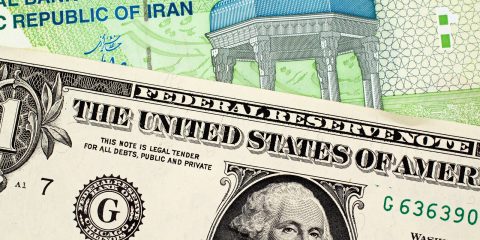 A Green 10000 Iranian Rial Note With An American One Dollar Bill