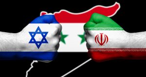 Flags of Israel and Iran painted on two clenched fists facing each other with flag of Syria in the background/Israel - Iran conflict concept