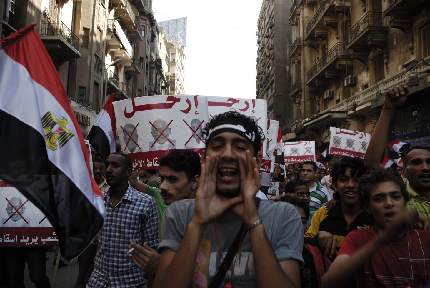 CAIRO - JUNE 30: Unidentified anti Muslim Brotherhood/Morsi protesters in Tahrir Square shout slogans calling for Morsi's resignation on June 30 2013 in Cairo Egypt.