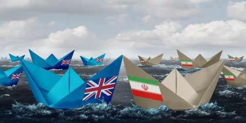 United Kingdom and Iran confrontation in the Persian gulf as a crisis in the middle east as Great Britain versus the Iranian government as paper boats representing shipping lane risk in a 3D illustration style.