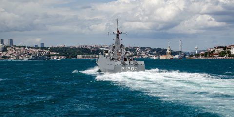 ISTANBUL TURKEY - JUNE 8 2016: The Navy patrol ship Tekirda sailing along the Bosphorus and the landmark Maiden's Tower in Uskudar. The Turkish ship is escorting the larger Russian frigate Admiral Grigorovich which can be seen to the left