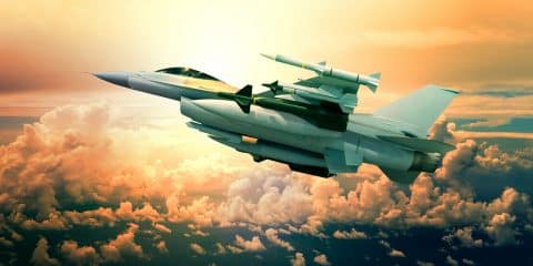 military jet plane with missile weapon flying against sunset sky use for world battle and political conflict in middle east
