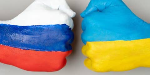 Flags of ukraine and russia flag on hands ukraine vs russia in world war crisis