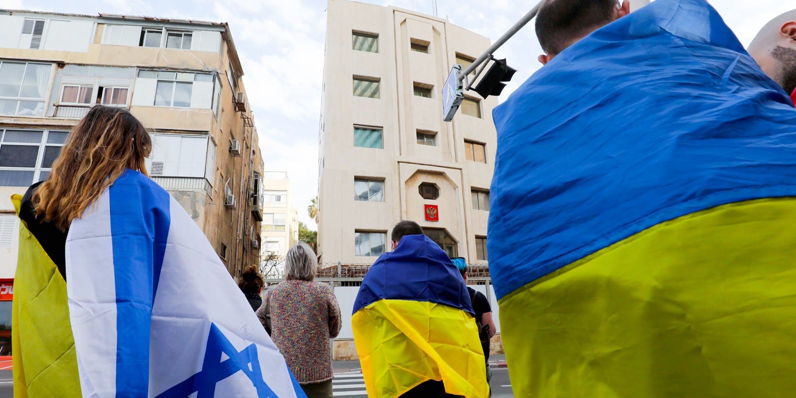 Israelis and Ukrainians living in Israel carry placards flags during a protest against Russia's invasion of Ukraine, in front of the Russian Embassy in Tel Aviv, Israel on February 24, 2022.