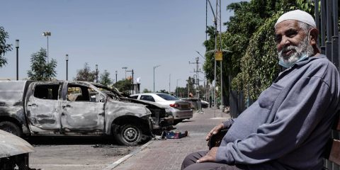 Lod, Israel: Debris and torched vehicles litter the streets of the mixed Jewish Arab city of Lod following a night of Arab rioting