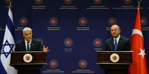 Turkish Foreign Minister Mevlut Cavusoglu (R) and Israeli Prime Minister Yair Lapid