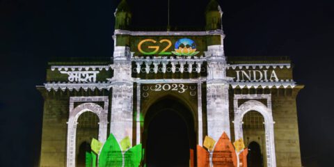 Gateway of India illuminated with colourful lights projecting India G20 Summit logo