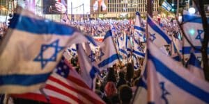 Protesters wave flags during the demonstration against the judicial reform