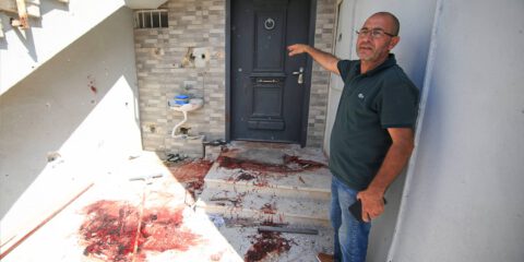 A man shows his house that is damaged after the firing with rockets by Palestinians