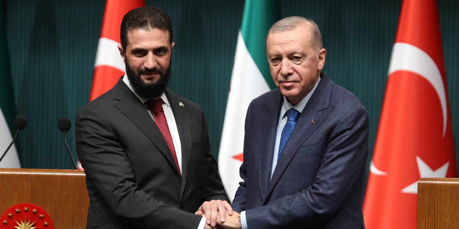Turkish President Recep Tayyip Erdogan (R) shakes hands with Syria s interim President Ahmed al-Sharaa during a joint press conference at the Presidential Complex in Ankara