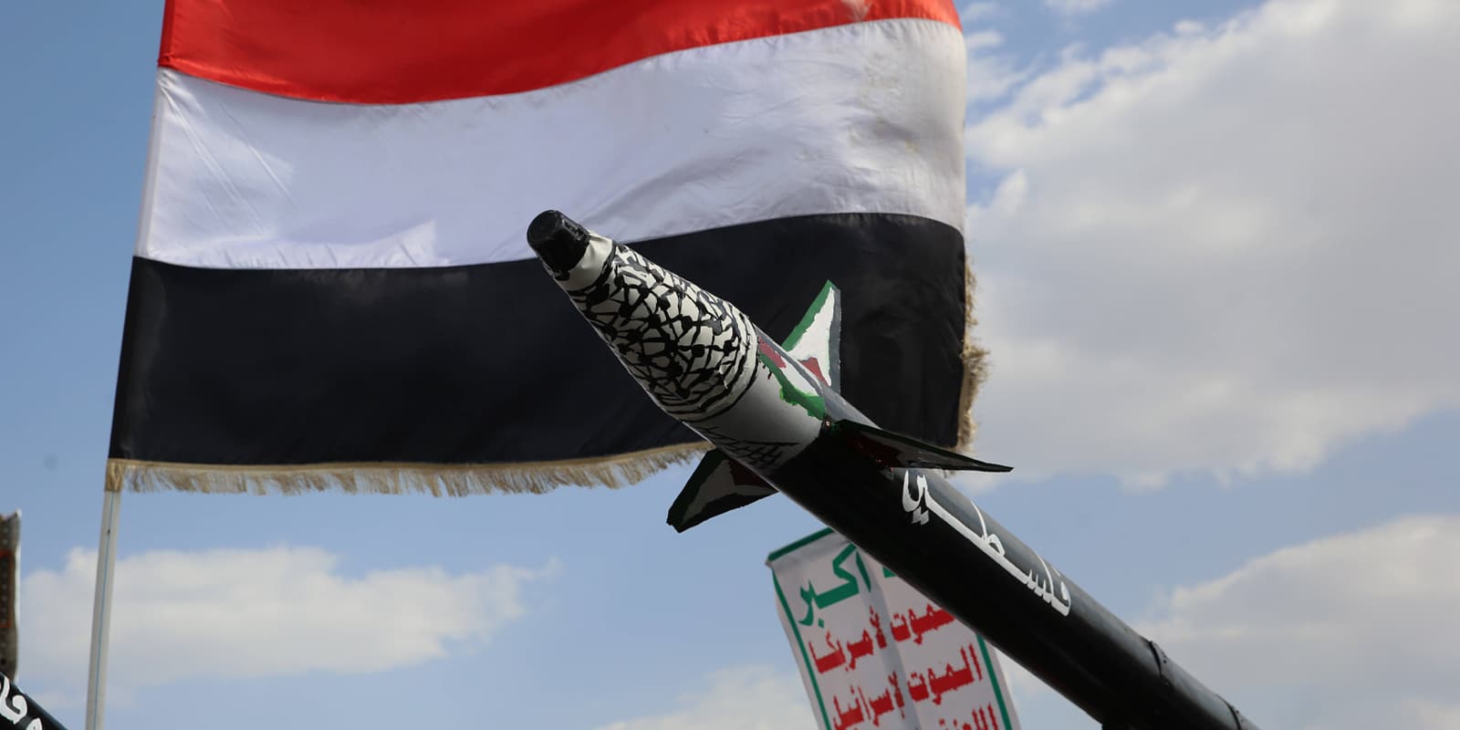 A Houthi supporter holds a mock rocket during an anti-Israel protest in Sana