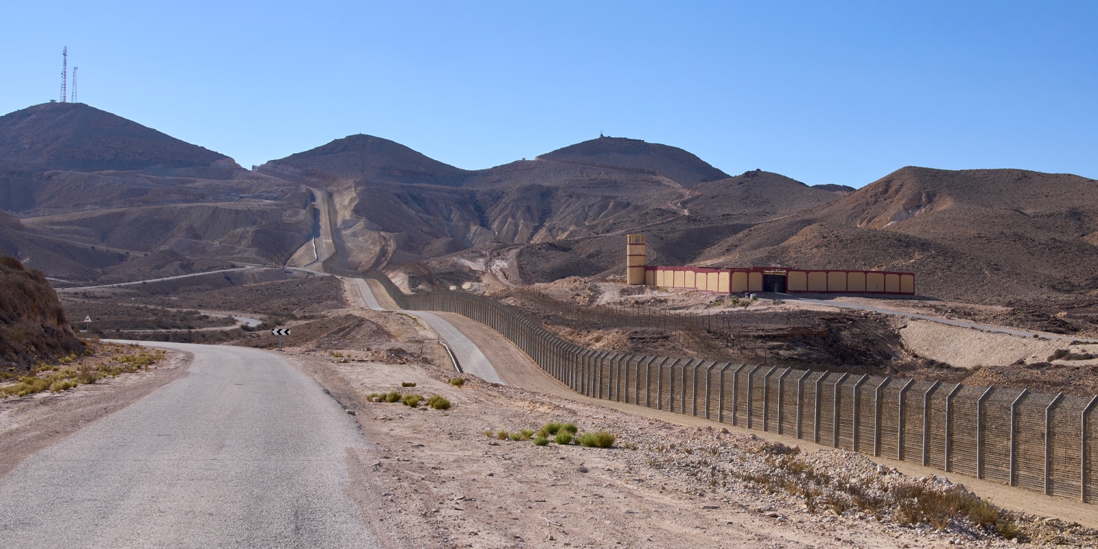 Restricted military zone along the border between Israel and Egypt along patrol road 10 in a remote part of the Negev desert and the Sinai desert. The border barbed wire fence along the road 10.