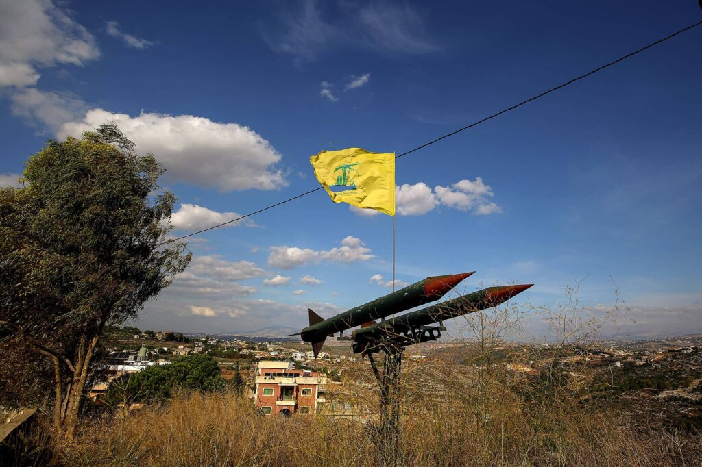 November 17, 2025, Burj Qalaway, Burj Qalaway, Lebanon: A pro-Iranian Hezbollah flag flutters over replica of missiles pointed towards Israel in the southern Lebanese village of Burj Qalaway.