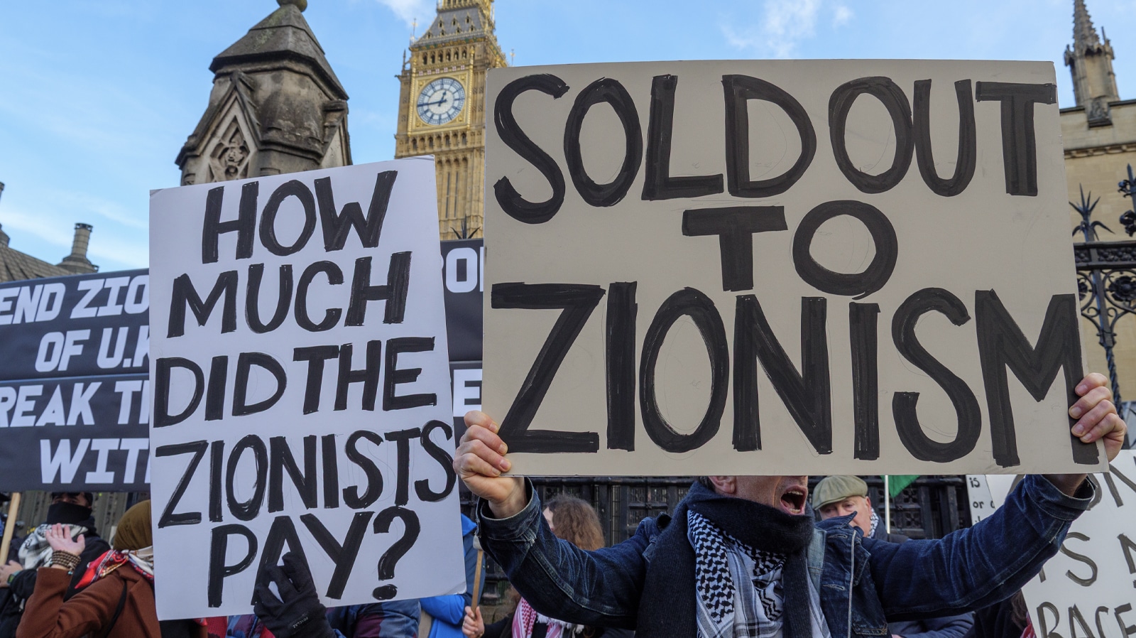 London, UK - January 28, 2026: Anti-Zionists holding signs pushing the antisemitic conspiracy about jewish control at a protest outside the Houses of Parliament